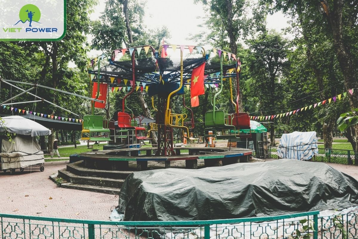 Rusty carousel and swings in Thong Nhat Park
